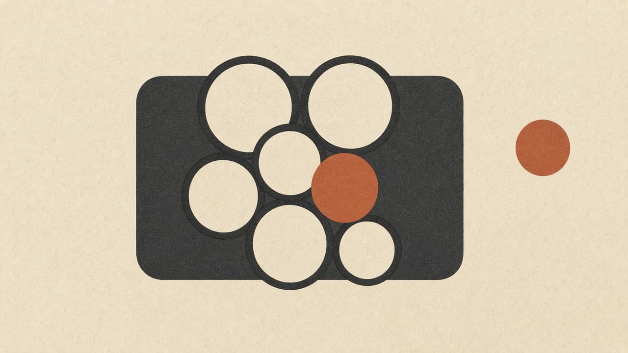Geometric cluster of circles with one terracotta disc beside a page frame